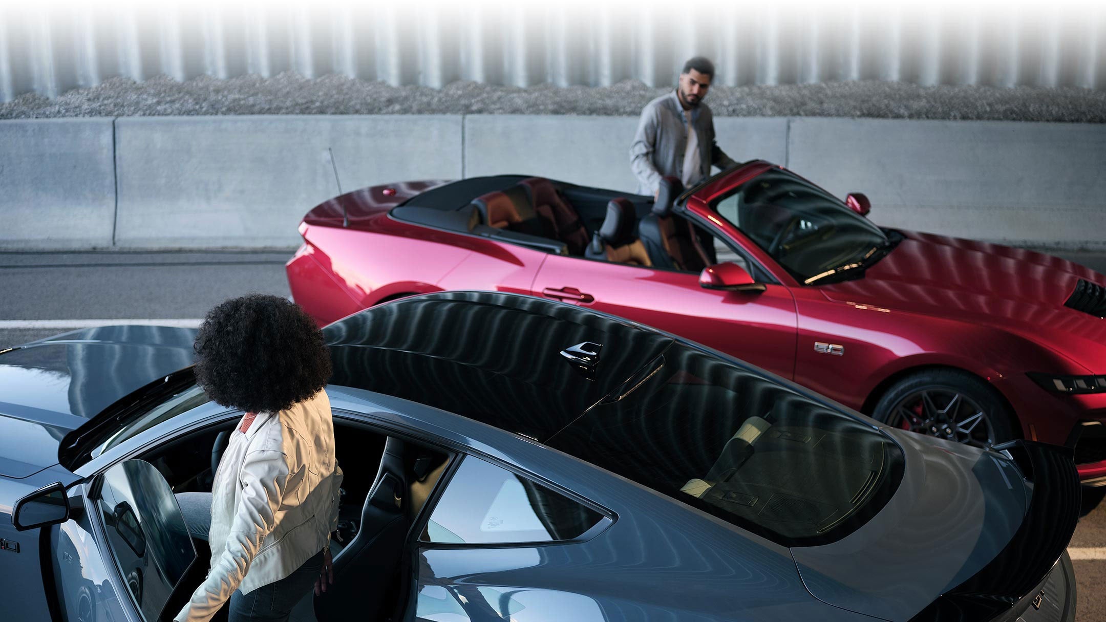 Two people exiting their parked 2024 Ford Mustang® coupe and convertible | Conroy Motor Corporation in Java Center NY