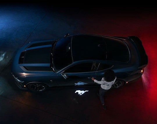 2024 Ford Mustang® Dark Horse™ model with a driver approaching the vehicle | Conroy Motor Corporation in Java Center NY