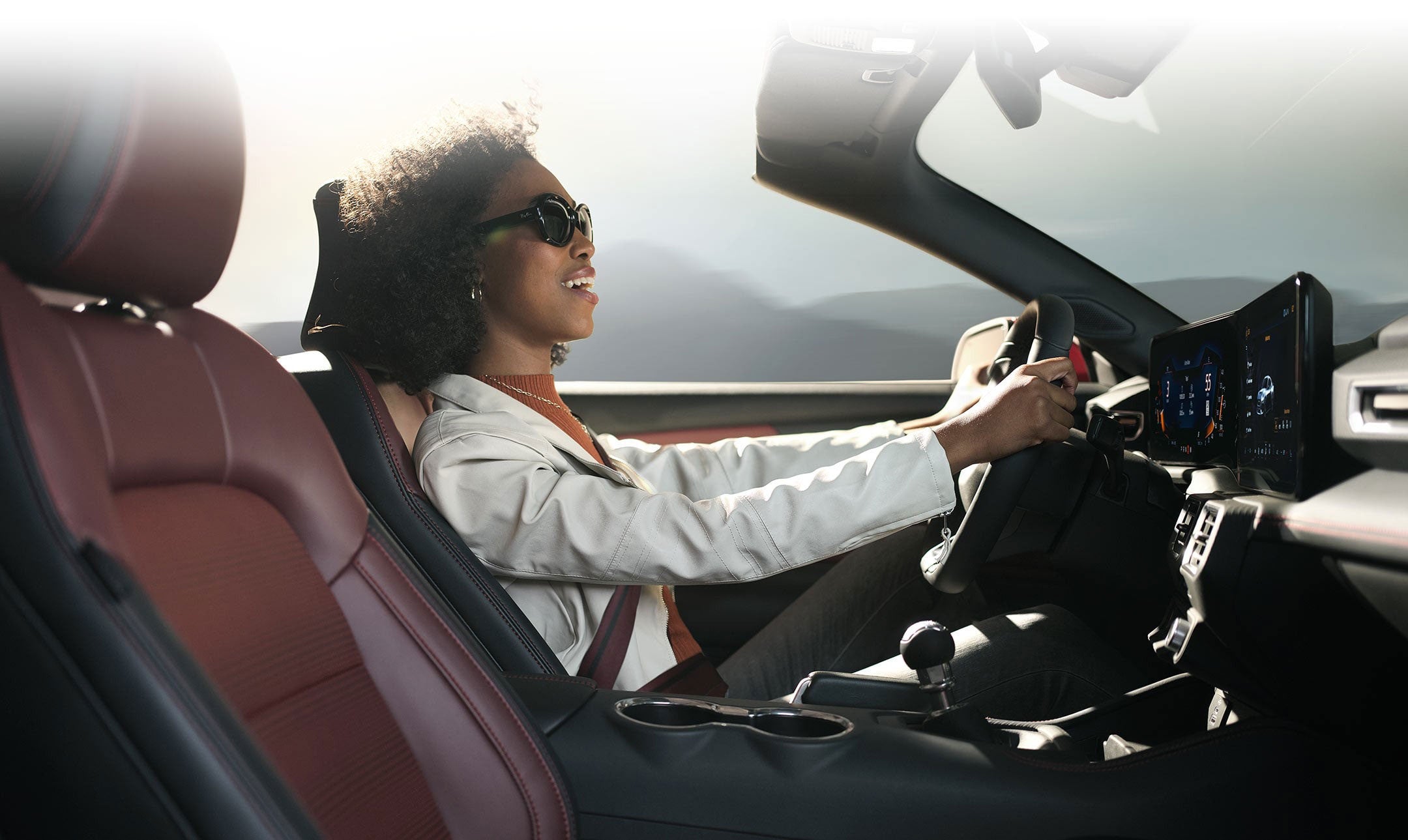Person sitting in the driver’s seat of a 2024 Ford Mustang® convertible | Conroy Motor Corporation in Java Center NY