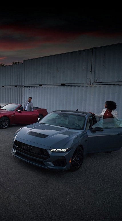 Two people exiting their parked 2024 Ford Mustang® coupe and convertible | Conroy Motor Corporation in Java Center NY